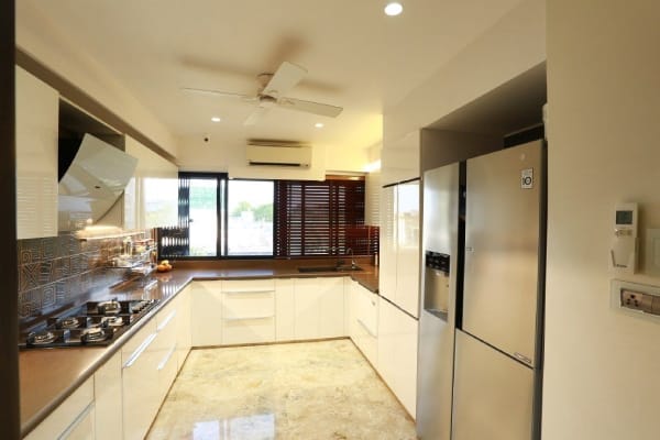 U-Shaped Modular Kitchen with Granite Countertop & Recessed Lighting