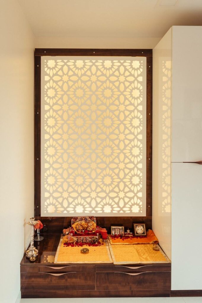 A Pooja Niche in a Wall with an Acrylic Backlit Panel in a Wooden Frame & Drawers at the Base for holding Idols to Worship!