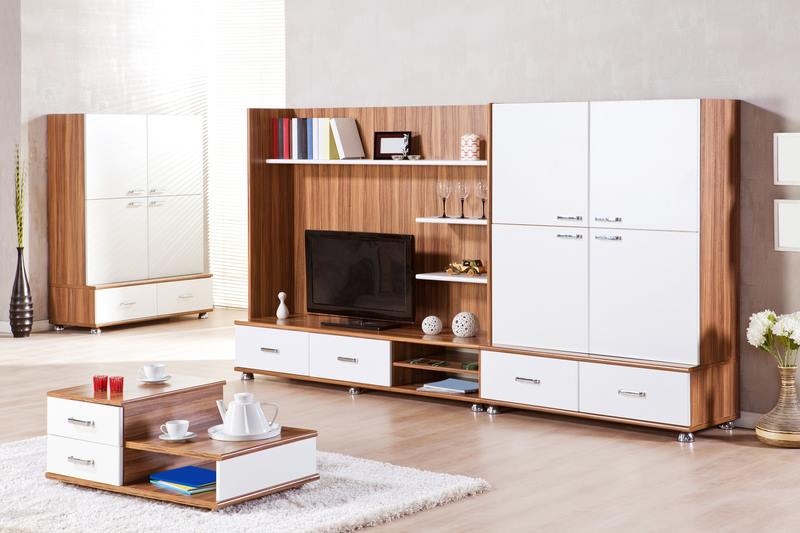 Wooden T.V. Unit designed with Storage Cabinet besides it, Linear Wooden Shelf for keeping Books, Flower Vase & Drawers below the T.V.