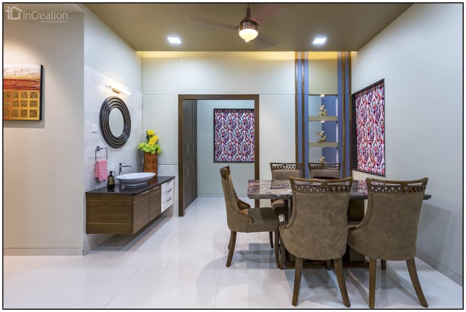 A modern elegant dining area with dining table of reflecting marble top and Victorian styled dining chairs with hemlock upholstery