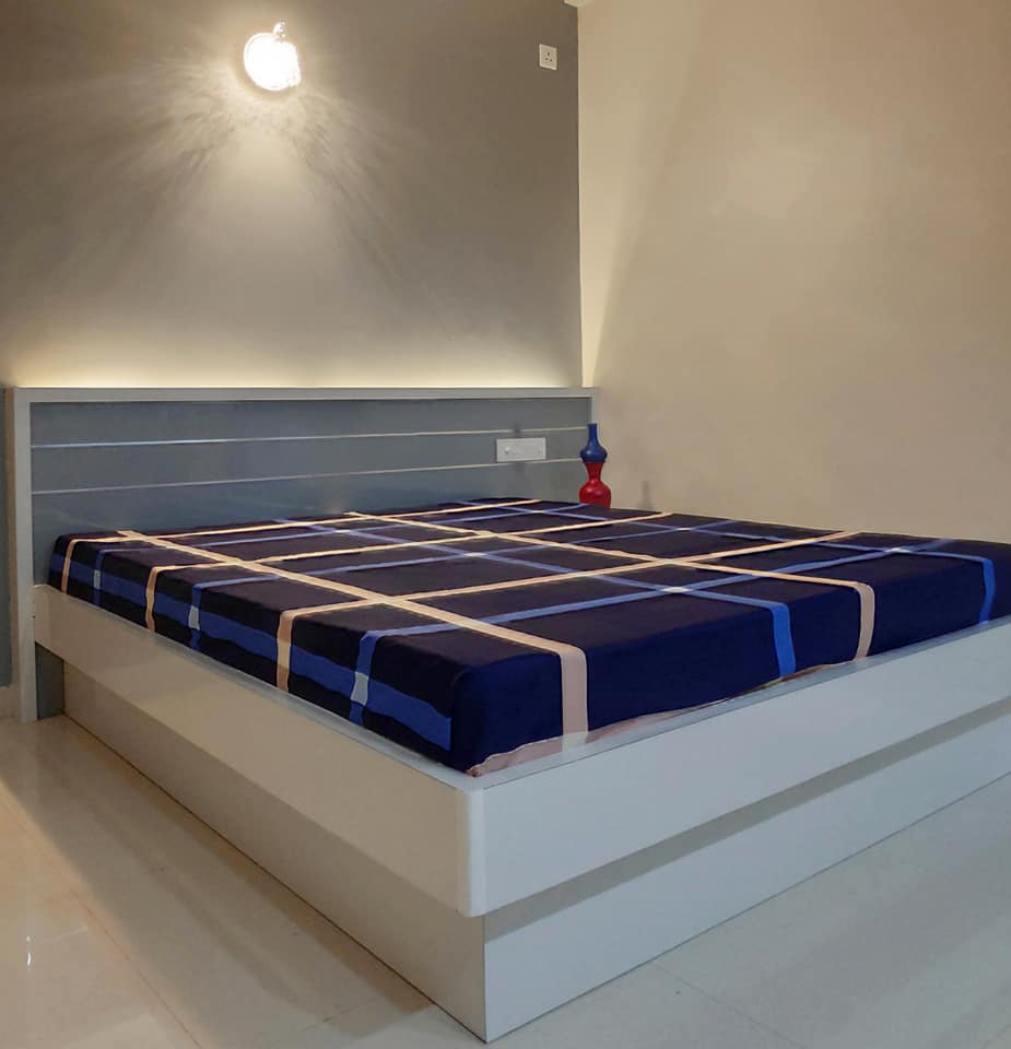 A white laminated overhanged bed