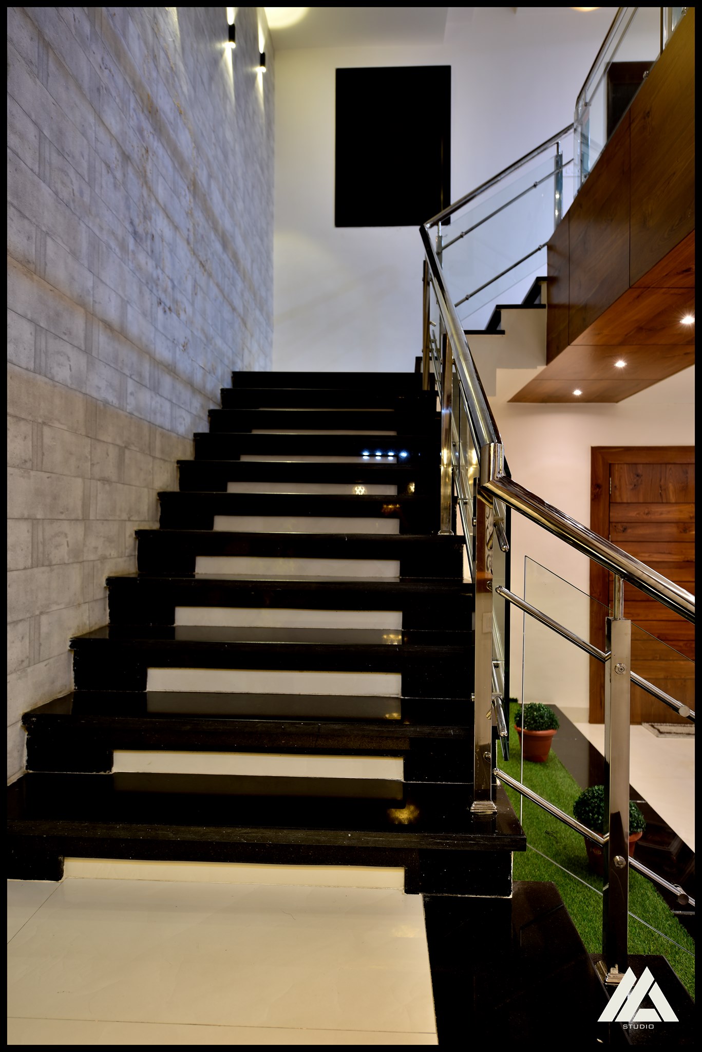 Steel and glass railing decorate the C shaped staircase
