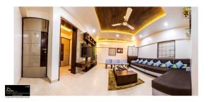 A living room in whites and brown with modern setup