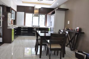 A modern dining area is placed on the side of an open-plan kitchen