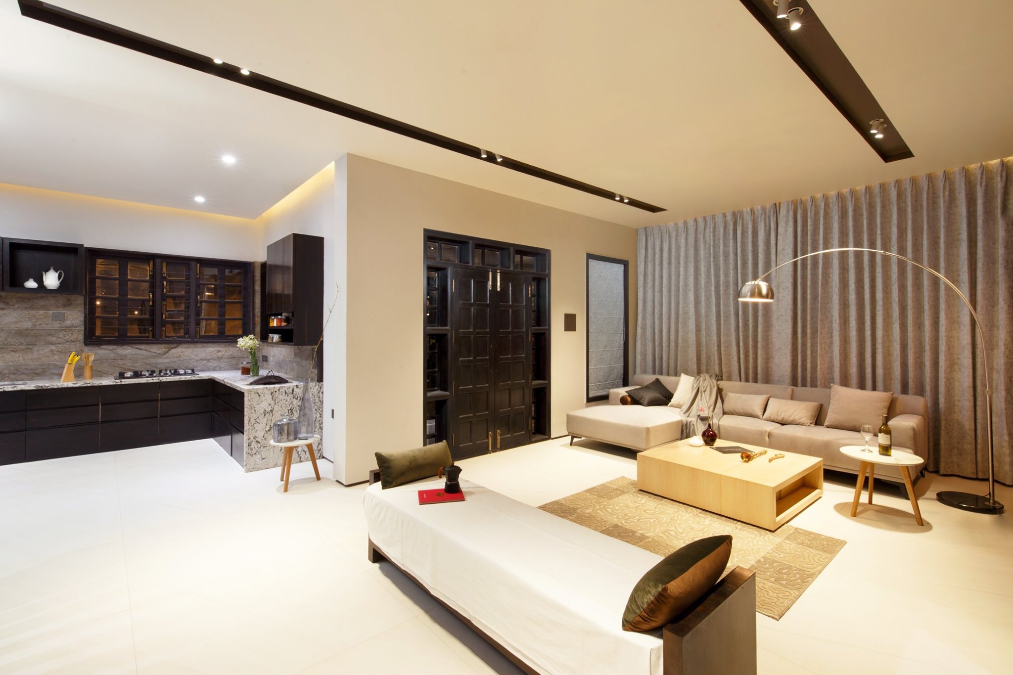 A modern living room with an open kitchen