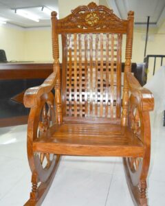 A solid wooden polished rocking chair