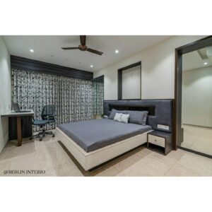 A modern compact bedroom in greys and white