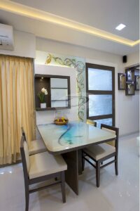 A Compact House has 4 Seater Dining Table with Acrylic Table Top & Wooden Framed Upholstered Chairs