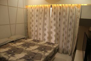 The Bedroom consists of Rectangular Wooden Bed & Wall Mounted T.V. Unit - 1