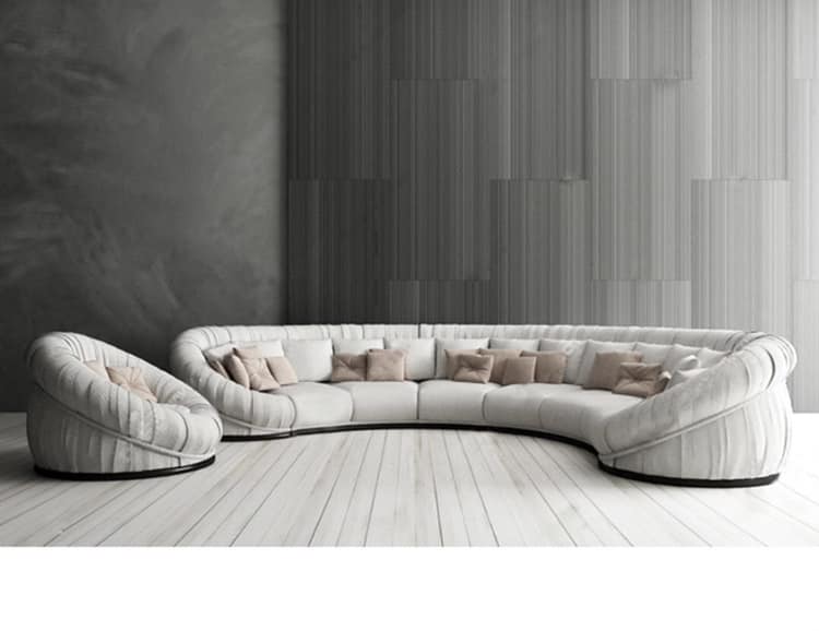 The Crescent Shape Off White Upholstered Sofa & a Single Seater Sofa together Looks Stylish