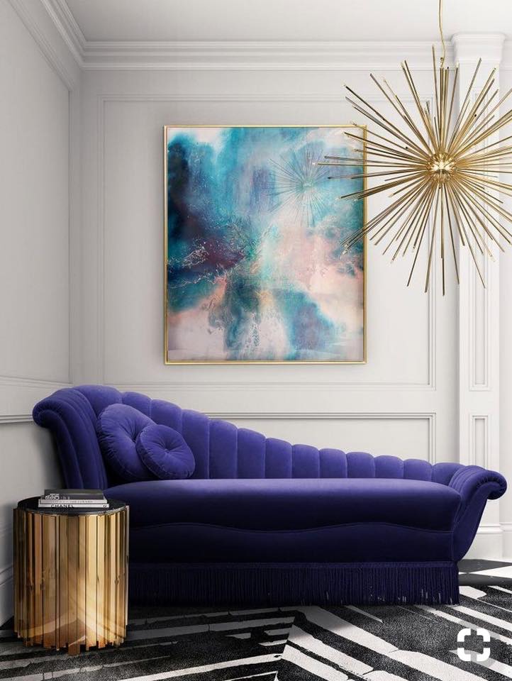 The Ink Blue Chaise Lounge Sofa having Velvet Upholstered is Nicely Placed in the Corner with Circular Metal Side Table