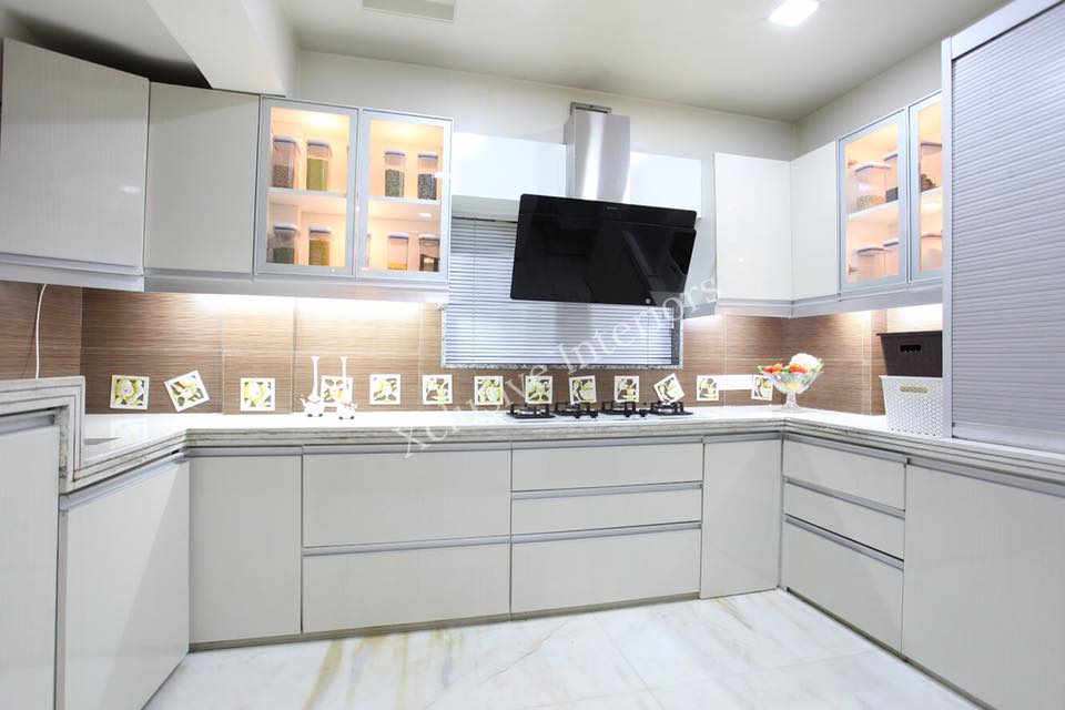 The C-Shape Kitchen Counter Consists of White Granite Top with a Built - In Gas Stove, Chimney & Single Bowl Sink