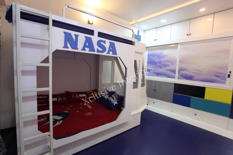 The Space Theme Bedroom with White Bunk Bed, Maroon & Blue Bedsheet with NASA is Connecting the Children with Their Dream